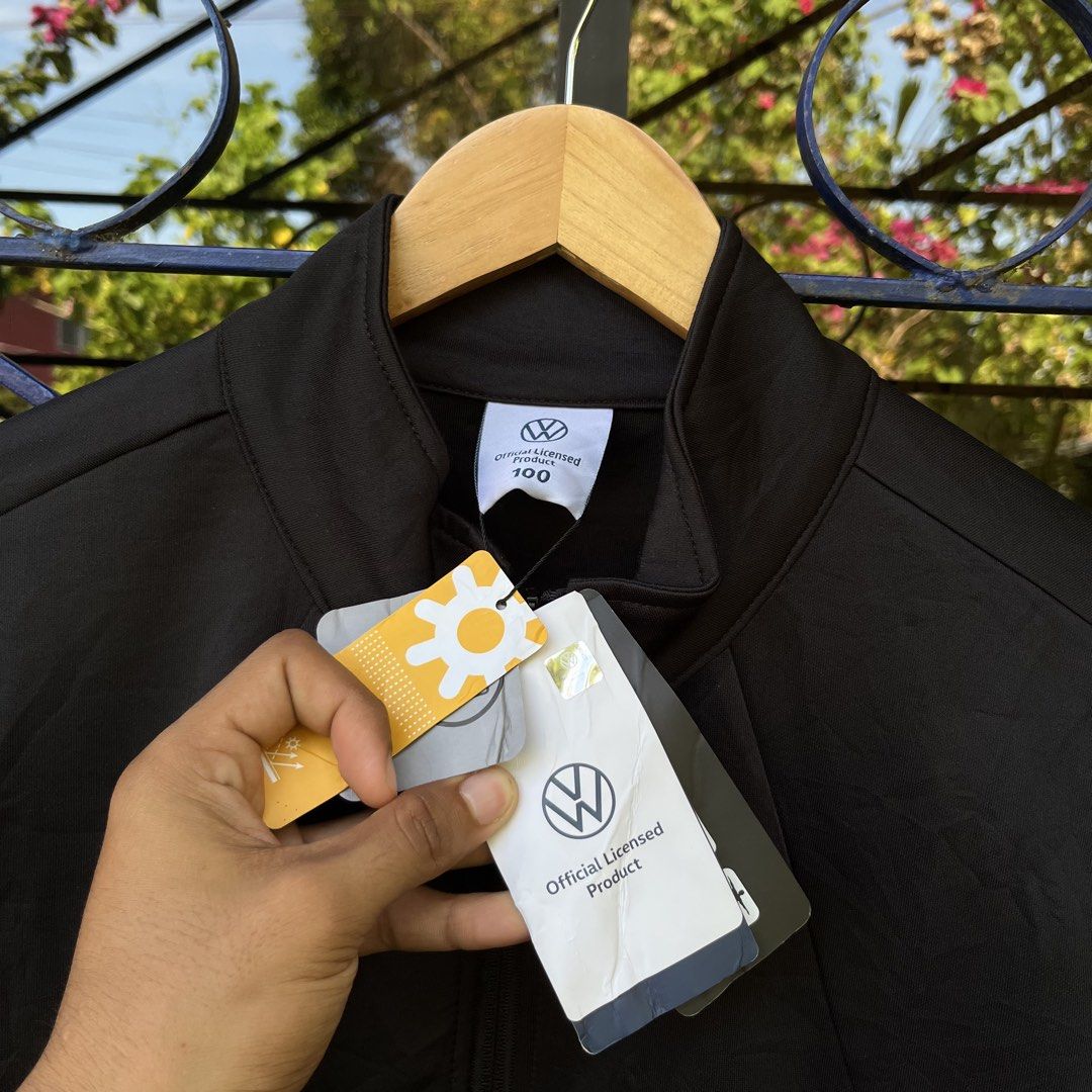 Official Volkswagen Black Zip Jacket Size 100 (Category: Coats, Jackets and Outerwear) located in Davao. Submitted by streetsight (Listing ID 1471020756, Image 3). Description: Official licensed Volkswagen jacket in black. Full zip front with branded pull tab. Small Volkswagen logo on the left chest and sleeve. Contrast dark grey side panels. Size 100 on the collar tag, fits heights 170 to 175cm. Material tag shows 97% polyester and 3% spandex bl