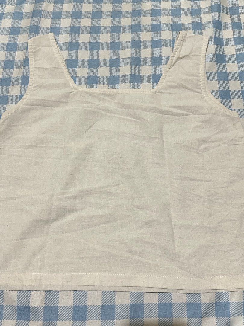 Off-white square neck tank top crop top (Category: Sleeveless) located in Mandaluyong City. Submitted by brightbird-5701 (Listing ID 1471062723, Image 1). Description: - Color: Off-white - Style: Minimalist crop top - Neckline: Square neck with thick straps - Hem: Straight hem - Fabric: Light, cotton-like material - Fit: Great for pairing with high-waisted jeans, skirts, or shorts - Condition: Brand new / Excellent.