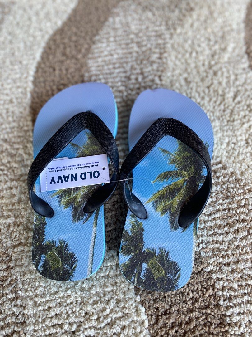 Old Navy Palm Tree Print Flip-Flops Size 10-11 (Category: Babies & Kids Fashion) located in Batangas. Submitted by lux_kimmy (Listing ID 1471043705, Image 1). Description: - Brand: Old Navy - Condition: Brand new with original store tag attached (Retail price: $5.99) - Size: 10-11 for 4-6Y - Design: Vibrant tropical palm tree print with blue footbed - Straps: Comfortable black textured straps - Status: Never worn, pristine condition.