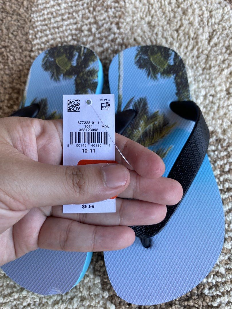 Old Navy Palm Tree Print Flip-Flops Size 10-11 (Category: Babies & Kids Fashion) located in Batangas. Submitted by lux_kimmy (Listing ID 1471043705, Image 3). Description: - Brand: Old Navy - Condition: Brand new with original store tag attached (Retail price: $5.99) - Size: 10-11 for 4-6Y - Design: Vibrant tropical palm tree print with blue footbed - Straps: Comfortable black textured straps - Status: Never worn, pristine condition.