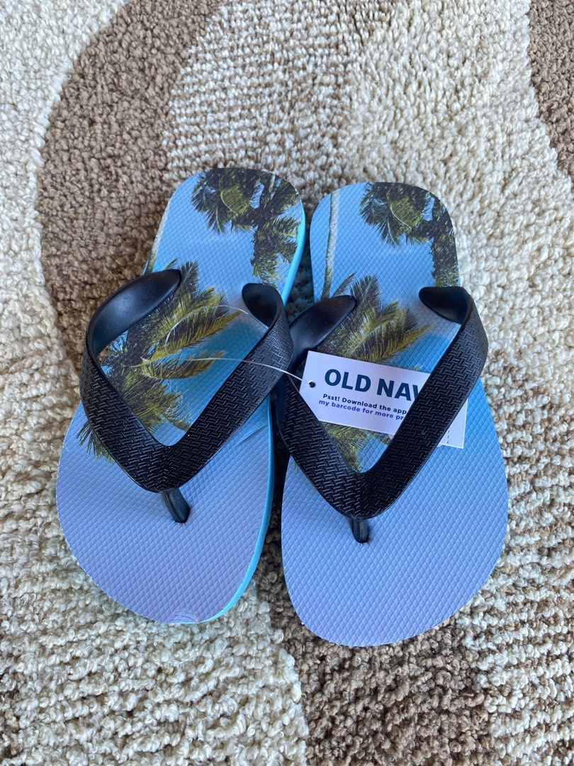 Old Navy Palm Tree Print Flip-Flops Size 10-11 (Category: Babies & Kids Fashion) located in Batangas. Submitted by lux_kimmy (Listing ID 1471043705, Image 2). Description: - Brand: Old Navy - Condition: Brand new with original store tag attached (Retail price: $5.99) - Size: 10-11 for 4-6Y - Design: Vibrant tropical palm tree print with blue footbed - Straps: Comfortable black textured straps - Status: Never worn, pristine condition.