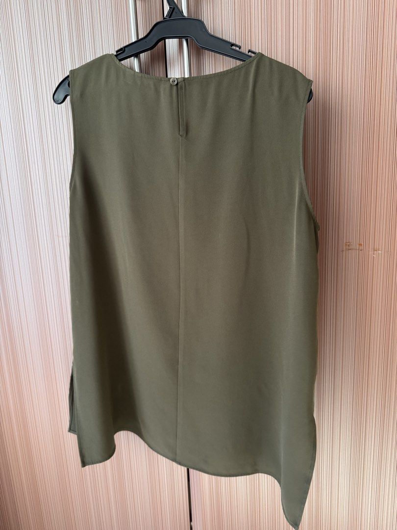 Olive Green Sleeveless Top Size XL (Category: Sleeveless) located in Manila. Submitted by k.pre_loved_collections (Listing ID 1471008227, Image 3). Description: - Item: Olive green sleeveless blouse - Size: XL - Details: Round neckline, back button closure with keyhole, side slits for extra movement - Fabric: Lightweight and easy to style for work or casual wear - Condition: Noticeable mild fabric fuzziness/wear on the front center area (closely 