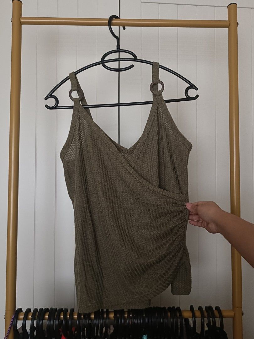 Olive Green Waffle Knit Wrap Tank Top (Category: Sleeveless) located in Bacoor. Submitted by Miss_Chuch0521 (Listing ID 1470963284, Image 1). Description: Army green cami with a wrap front and ruching on the side. Straps have wooden ring accents. Textured waffle knit material, stretchy and comfortable. V-neckline. Great to pair with jeans or shorts..