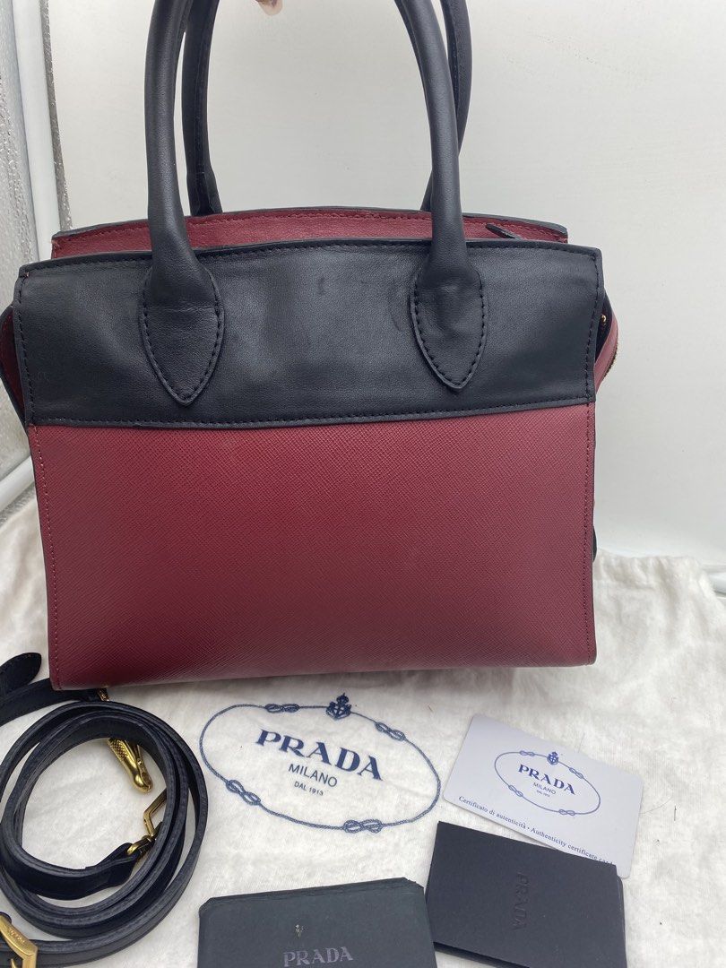 Orig Prada Esplanade Leather Handbag Red Black (Category: Luxury Bags & Wallets) located in Bacolod City. Submitted by chuchaystuffs (Listing ID 1470944904, Image 3). Description: - Authentic Prada Esplanade Handbag - Material: Premium Saffiano leather in contrasting red and black - Hardware: Gold-tone with iconic Prada Milano lettering - Design: Structured trapezoid silhouette with top zip closure - Versatility: Dual top handles and a detachable