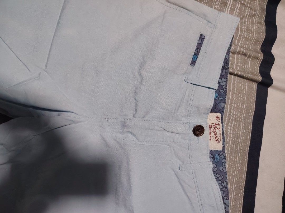 Original Penguin Light Blue Shorts Size 32 (Category: Shorts) located in Manila. Submitted by snooks1938 (Listing ID 1471097404, Image 2). Description: - Brand: Original Penguin - Size: 32 - Color: Light blue - Closure: Button closure - Pockets: Front coin pocket and back welt pockets with penguin logo embroidery - Details: Blue floral print fabric lining on the interior waistband - Origin: Made in Vietnam - Condition/Style: Classic casual shorts