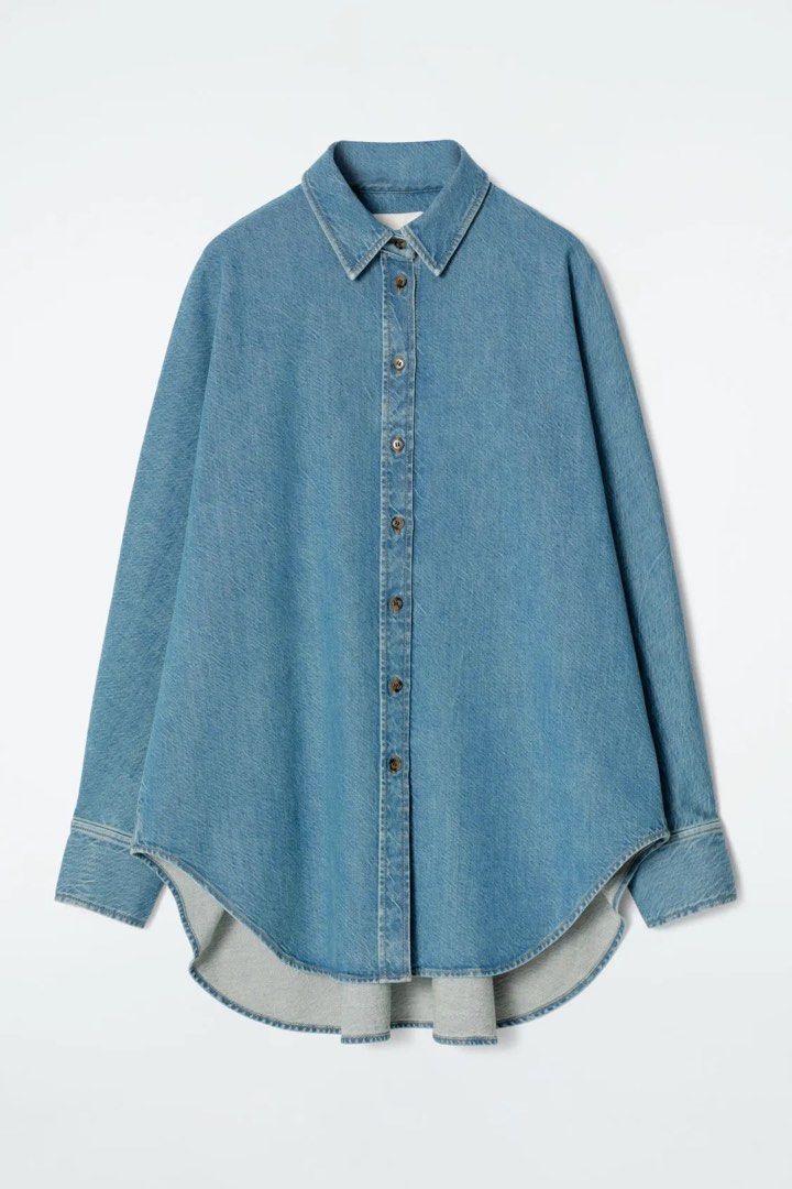 Oversized Denim Shirt Light Blue (Category: Shirts) located in Tanza. Submitted by deeclutterer (Listing ID 1471028596, Image 1). Description: COS Relaxed Denim Shirt Cut in a loose (Oversize) billowing silhouette from organic cotton denim, features a classic pointed collar, tonal buttons, and a pronounced curved, stepped hemline Medium-Large ₱1,599.