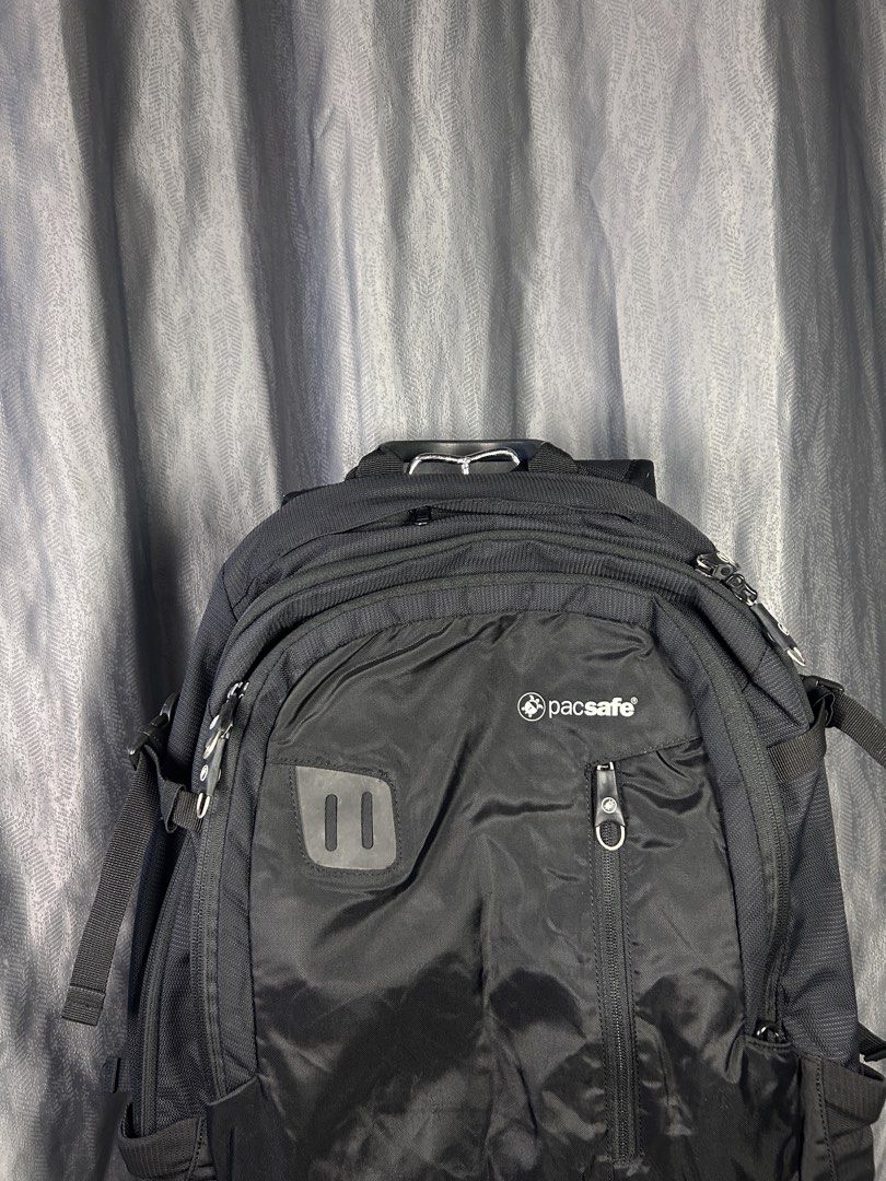 Pacsafe Venturesafe 25L Anti-Theft Backpack (Category: Backpacks) located in General Mariano Alvarez. Submitted by manosegunda4117 (Listing ID 1471020181, Image 3). Description: Pacsafe Venturesafe 25L Anti-Theft Backpack • Brand & Style: Black anti-theft travel backpack made by Pacsafe. • Anti-Theft Technology: Equipped with wire-reinforced slashguard straps, eXomesh slashguard material to prevent cutting, lockable/secure zipper systems, and RFI