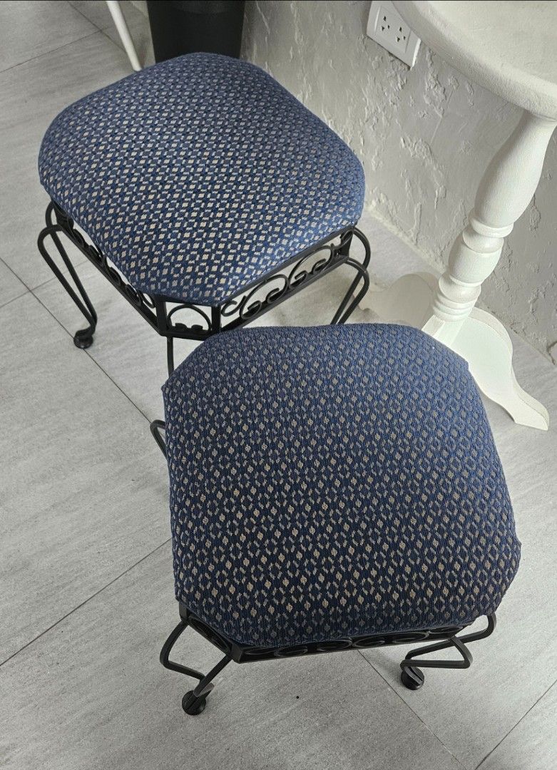 Pair of Wrought Iron Stools with Blue Patterned Cushions (Category: Chairs) located in Manila. Submitted by cosmicshark-cd31f1 (Listing ID 1471025946, Image 3). Description: - Set of 2 matching stools - Black wrought iron frames with decorative scrollwork - Upholstered cushion tops in a blue geometric diamond pattern - Curved legs for sturdy and reliable support - Perfect extra seating for the living room, vanity, or bedroom corners - Clean condi