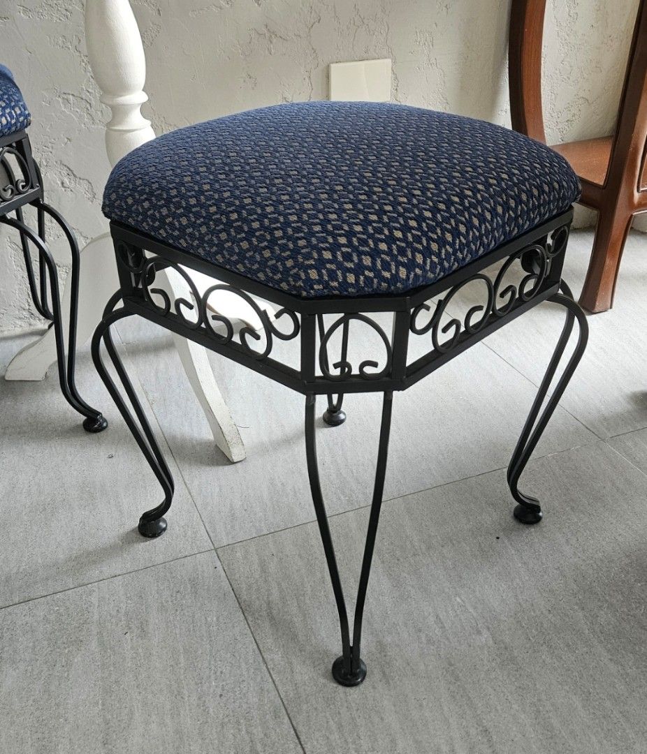 Pair of Wrought Iron Stools with Blue Patterned Cushions (Category: Chairs) located in Manila. Submitted by cosmicshark-cd31f1 (Listing ID 1471025946, Image 2). Description: - Set of 2 matching stools - Black wrought iron frames with decorative scrollwork - Upholstered cushion tops in a blue geometric diamond pattern - Curved legs for sturdy and reliable support - Perfect extra seating for the living room, vanity, or bedroom corners - Clean condi