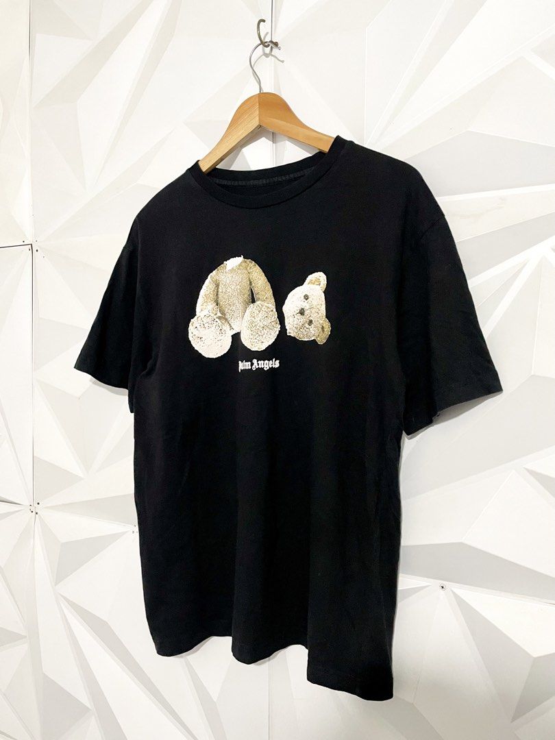 Palm Angels Bear Black T-Shirt (Category: Shirts) located in Cabuyao City. Submitted by ParadisethriftedPh (Listing ID 1471118335, Image 2). Description: Cr: 9.2/10 Dimensions W: 20.5 L: 27 - Brand: Palm Angels - Color: Classic Black - Design: Iconic bear graphic on front with bold white gothic lettering on back shoulders - Fit: Short sleeves, crew neck - Material: Premium cotton - Style: Clean streetwear staple, highly versatile - Condition: Bra