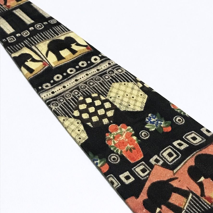 Parksdea Vintage Hand Made Collage Pattern Black Neck Tie (Category: Ties) located in Taguig. Submitted by retrogaze (Listing ID 1471030174, Image 3). Description: This vintage handmade necktie by Parksdea features a solid black base printed with an eclectic, artistic collage pattern arranged in horizontal registers. The design combines stylized elephant silhouettes framed in warm terracotta-orange, cream, and mustard blocks, paired with checkere