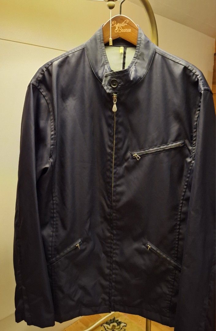 Paul Smith London Navy Bomber Jacket (Category: Coats, Jackets and Outerwear) located in Baguio. Submitted by give_fad15730 (Listing ID 1471074181, Image 3). Description: - Brand: Paul Smith London - Color: Navy Blue - Size: Large - Closure: Front zip with stand collar and button fastening - Pockets: One chest pocket and two side pockets with zipper details - Design: Smooth fabric exterior with clean back seam detailing - Condition: Great outer l