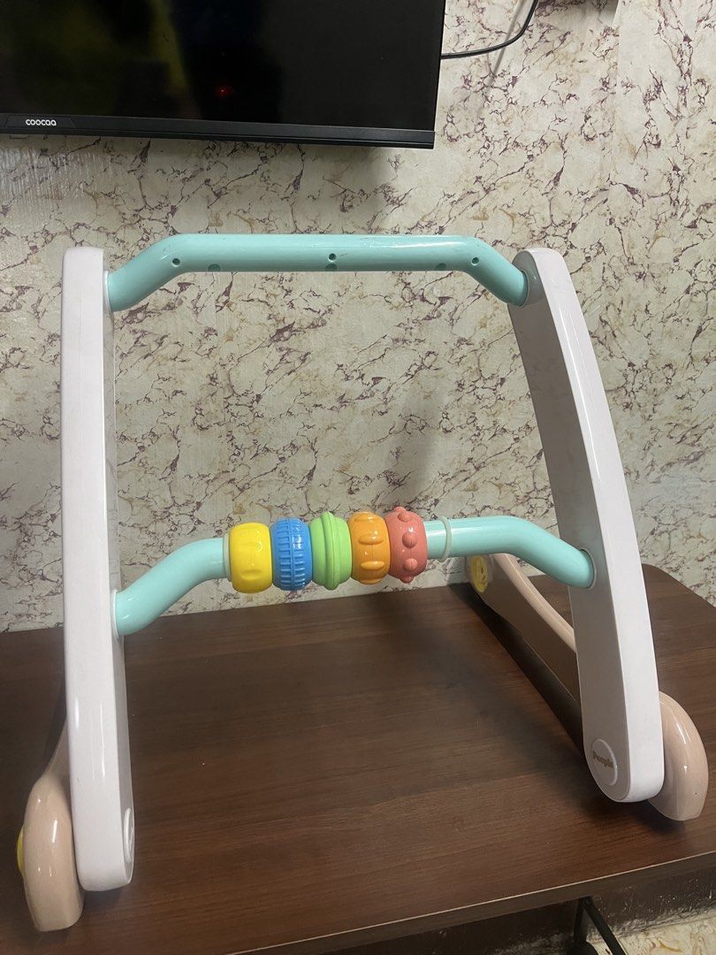People Baby Walker Toy with Beads (Category: Infant Playtime) located in Manila. Submitted by kayerrr.gem (Listing ID 1471048745, Image 1). Description: - Brand: People baby walker toy - Design: Pastel frame with multi-colored spinning beads - Safety & Mobility: Wheels feature rubber grips and adjustable resistance locks - Build: Solid and sturdy to help little ones learn to walk - Condition note: Has some tiny orange marks on the turquoise bar.