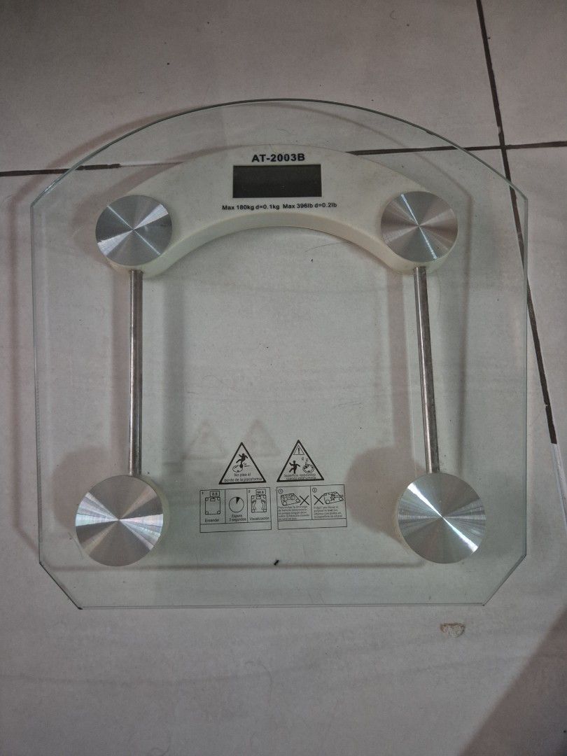 Personal Scale AT-2003B Digital Bathroom Scale (Category: Health Monitors & Weighing Scales) located in Manila. Submitted by matthew34567 (Listing ID 1471004391, Image 1). Description: - Model: AT-2003B Digital Personal Scale - Max capacity: 180kg - Design: Clear glass platform with stylish silver circular pad accents - Display: Clear digital screen for accurate weight readings - Condition: Fully operational and ready to use - Packaging: Comes wi