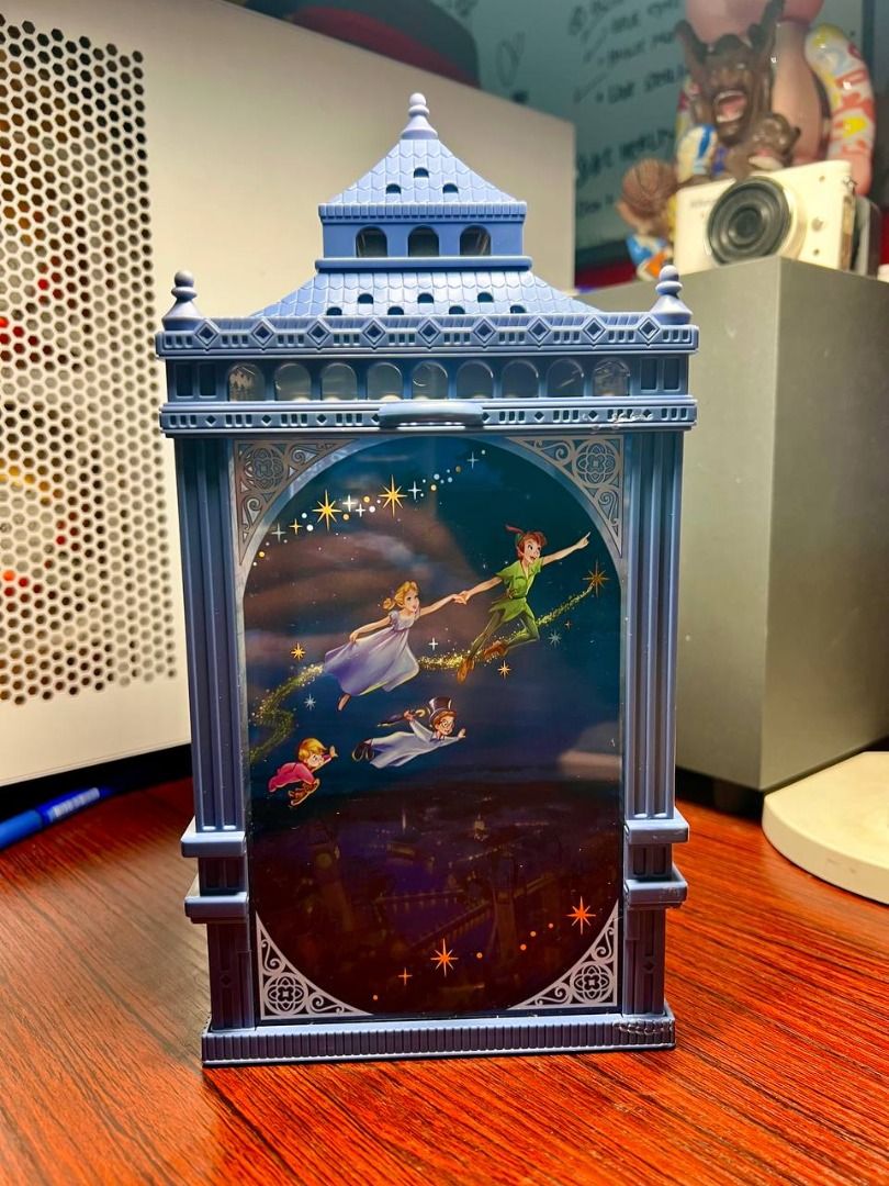 Peter Pan Clock tower Light Up PopCorn bucket (Category: Lighting) located in Baguio. Submitted by ditoyzb08176 (Listing ID 1471067065, Image 3). Description: - Official Disney Peter Pan lantern shaped like the Big Ben clock tower - Durable blue plastic frame with glowing illustrated panels - Panel 1: Peter Pan, Wendy, John, and Michael flying over London - Panel 2: Captain Hook and Smee on a pirate ship near Neverland - Clock face side features 