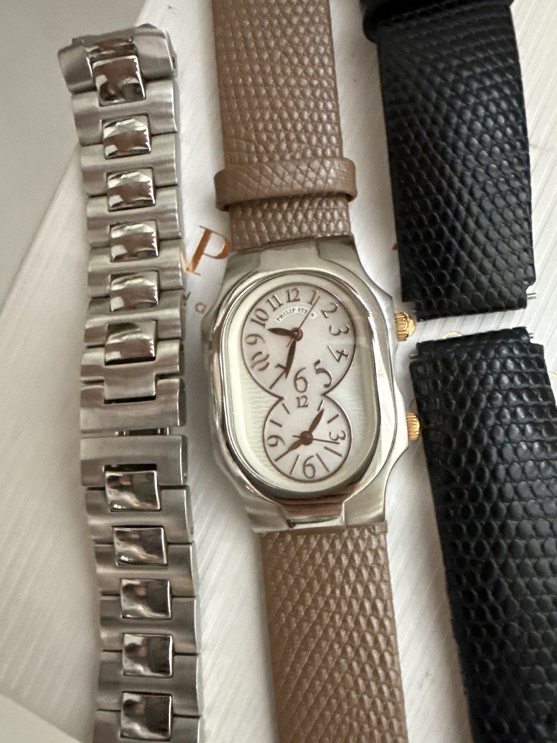 Philip Stein Dual Time Watch with Box and Extra Straps (Category: Women's Watches) located in Bulacan. Submitted by mynicetreasure (Listing ID 1470939844, Image 2). Description: - Brand: Philip Stein - Mother of Pearl face - Design: Dual time zone with silver dials and stainless steel case - Crowns: Two separate crowns on the right side - Inclusions: Original white box - Straps included: Mounted brown leather strap, spare black leather strap, and
