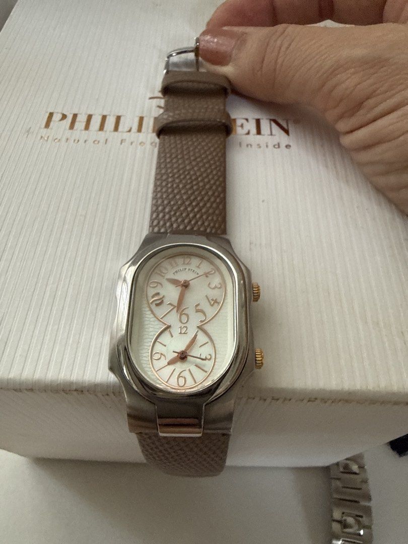 Philip Stein Dual Time Watch with Box and Extra Straps (Category: Women's Watches) located in Bulacan. Submitted by mynicetreasure (Listing ID 1470939844, Image 1). Description: - Brand: Philip Stein - Mother of Pearl face - Design: Dual time zone with silver dials and stainless steel case - Crowns: Two separate crowns on the right side - Inclusions: Original white box - Straps included: Mounted brown leather strap, spare black leather strap, and