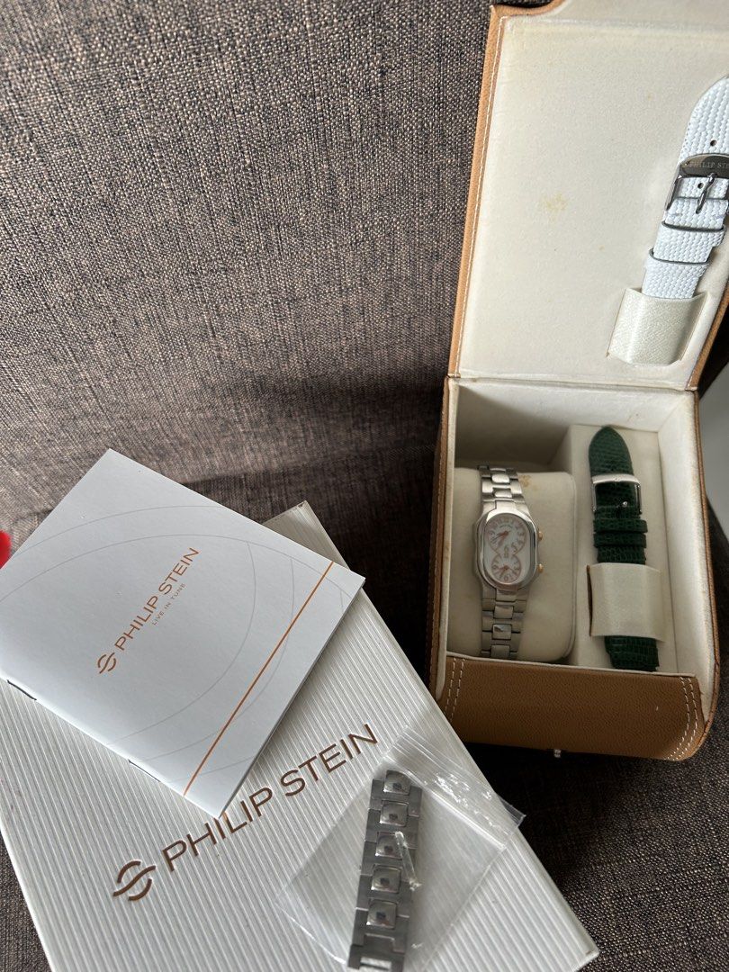 Philip Stein Dual Time Zone Watch with Extra Straps (Category: Women's Watches) located in Taguig. Submitted by shopourstyle.co (Listing ID 1470934842, Image 1). Description: - Authentic Philip Stein dual time zone wristwatch - Elegant stainless steel bracelet with gold crown accents - Reliable battery-operated quartz movement with dual Arabic numeral dials - Includes 2 interchangeable leather straps (Green and White) - Comes with extra metal lin