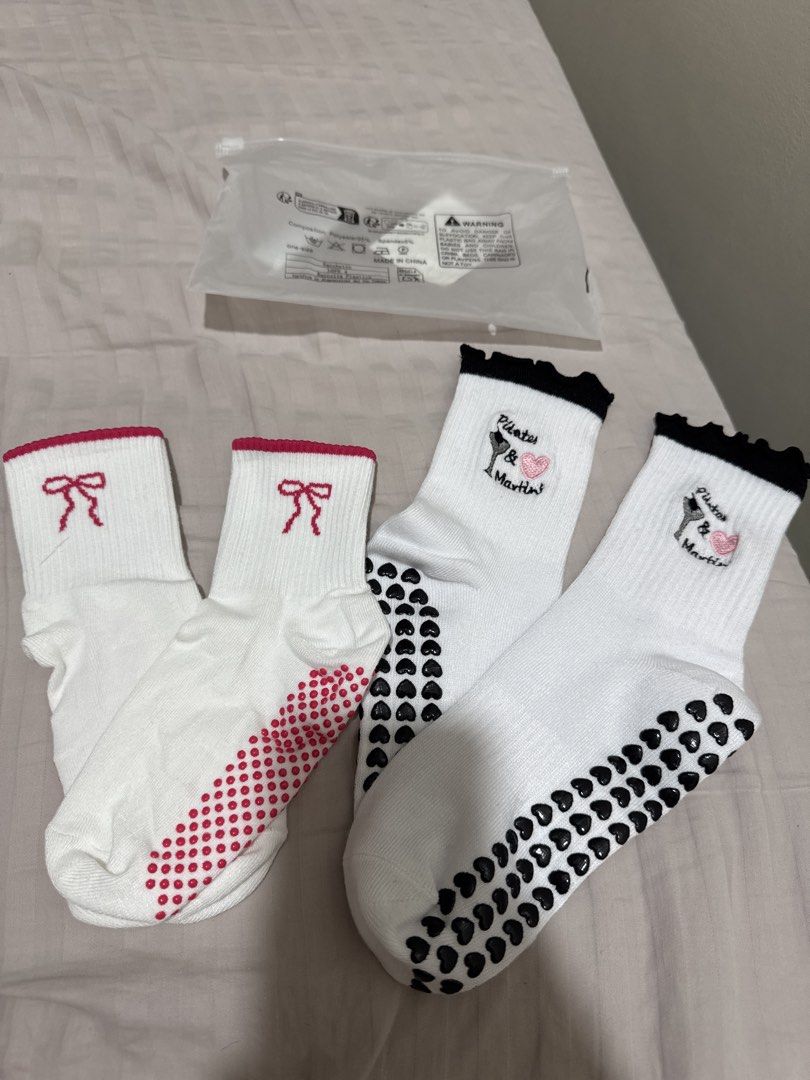Pilates Grip Socks 2 Pairs White Pink Bow Black (Category: Socks & Tights) located in Bacoor. Submitted by decluterwithellie8 (Listing ID 1471060263, Image 1). Description: - Bundle includes 2 pairs of trendy white grip socks - Pair 1: Pink ribbed cuffs, pink bow embroidery, and pink dot grips - Pair 2: Black ribbed cuffs, wine glass with pink heart embroidery, and black heart-shaped grips - Condition: Brand new - Perfect for pilates, barre, yoga