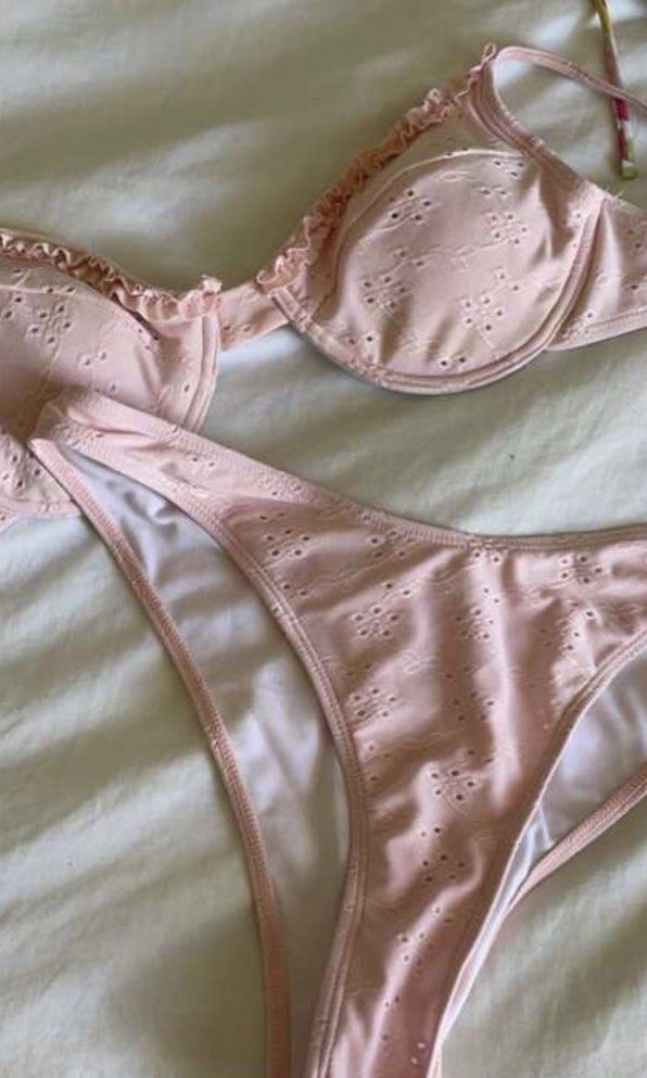 Pink Floral Eyelet Ruffle Bikini Set (Category: Bikinis & Swimsuits) located in Manila. Submitted by ashie0 (Listing ID 1470940214, Image 1). Description: - Color: Light pink with delicate eyelet floral pattern - Top: Underwire bra with playful ruffle edges and adjustable straps - Bottoms: Standard waist fit with soft white inner lining - Condition: Worn once for a quick outdoor night shoot, freshly washed and sanitized .