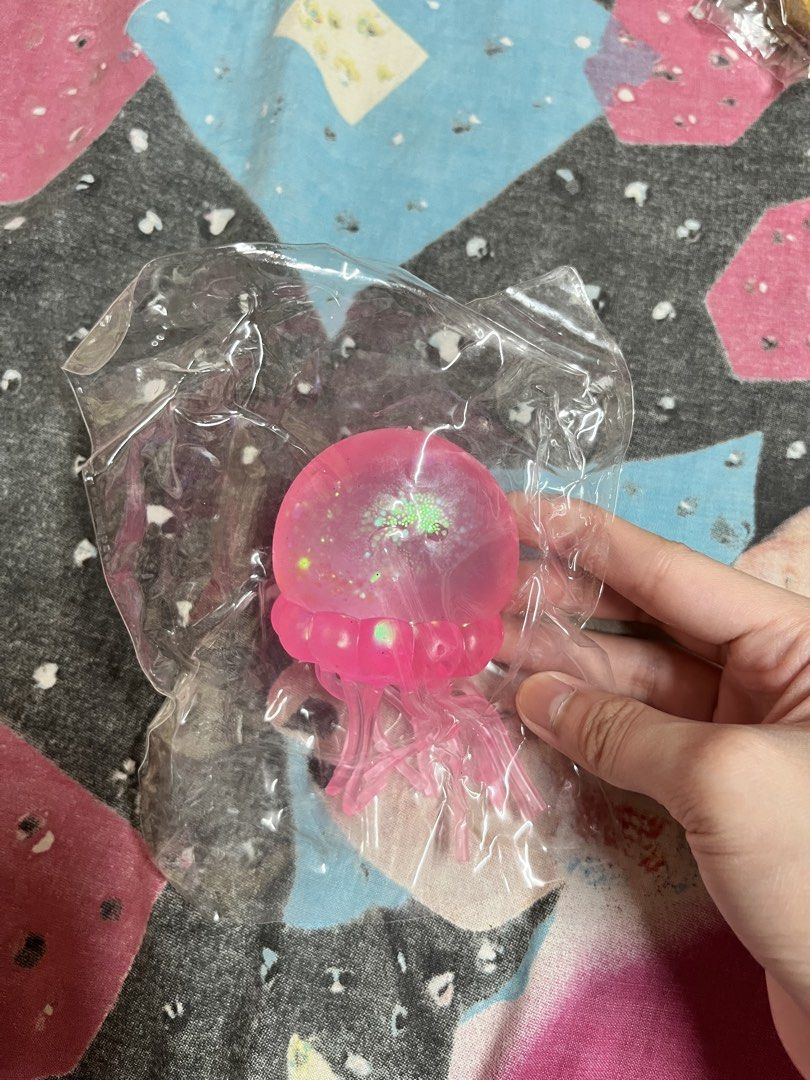 Pink Jellyfish Squishy Toy with Glitter (Category: Kids Toys) located in Manila. Submitted by leiluvsu (Listing ID 1471085798, Image 1). Description: - glitter pink jellyfish squishy toy needoh - Filled with sparkling glitter in the dome and tentacles - Made from a soft, stretchy, stress-relieving material - Great as a fidget toy or cute desk decoration - Compact size (measures a few inches wide).