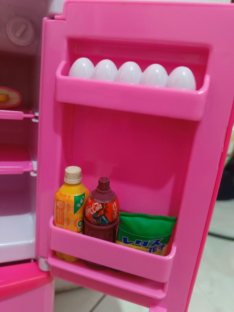 Pink Plastic Toy Refrigerator Playset with Accessories (Category: Kids Toys) located in Manila. Submitted by xxxmateo (Listing ID 1470972287, Image 3). Description: - Adorable pink and white toy refrigerator for kids' playtime - Realistic double-door design with opening bottom freezer drawers - Features a fun pretend water dispenser on the front door - Comes with miniature play food: shake cup, ice cream cone, popsicles, soda cans, snacks, and eg