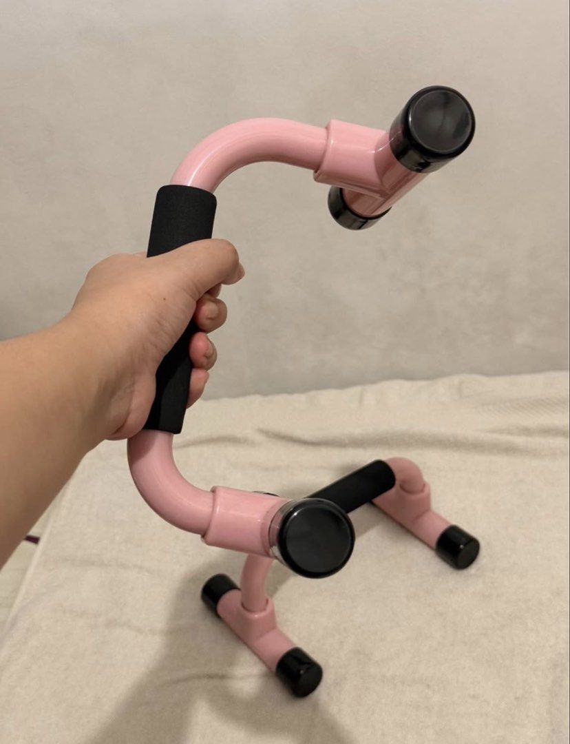 Pink Push Up Bars Workout Handles (Category: Cardio & Fitness Machines) located in Manila. Submitted by daniii_tree (Listing ID 1471065799, Image 2). Description: - Color: Pink with black foam grips - Sturdy plastic construction for daily home workouts - Non-slip rubber caps protect your floors - Targets chest, shoulders, and arms - Compact size for easy storage.