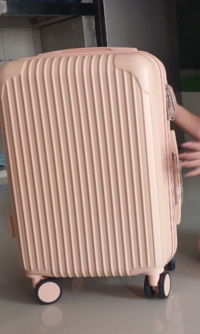 Pink ribbed hardside rolling luggage with spinner wheels (Category: Luggage) located in Manila. Submitted by silentcat.202107 (Listing ID 1471099428, Image 2). Description: - Color: Stylish pink with horizontal ribbed exterior - Size: Compact cabin size, ideal for short trips - Mobility: 4 smooth-rolling spinner wheels and retractable top handle - Closure: Secure zip closure - Interior: Clean and spacious inside - Condition: Minor signs of handli