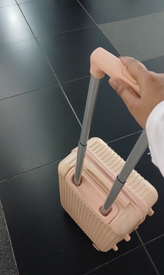 Pink ribbed hardside rolling luggage with spinner wheels (Category: Luggage) located in Manila. Submitted by silentcat.202107 (Listing ID 1471099428, Image 1). Description: - Color: Stylish pink with horizontal ribbed exterior - Size: Compact cabin size, ideal for short trips - Mobility: 4 smooth-rolling spinner wheels and retractable top handle - Closure: Secure zip closure - Interior: Clean and spacious inside - Condition: Minor signs of handli