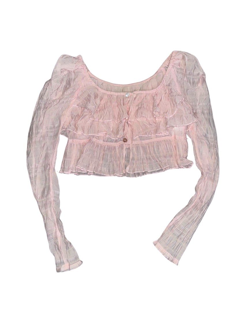 Pink Ruffle Long Sleeve Crop Top (Category: Longsleeves) located in Alicia. Submitted by lovedby.icy (Listing ID 1471055302, Image 1). Description: | cute coquette style crop top | long sleeves, layered ruffles across the front, scoop neckline, and button-up front closure | light textured fabric, slightly sheer.