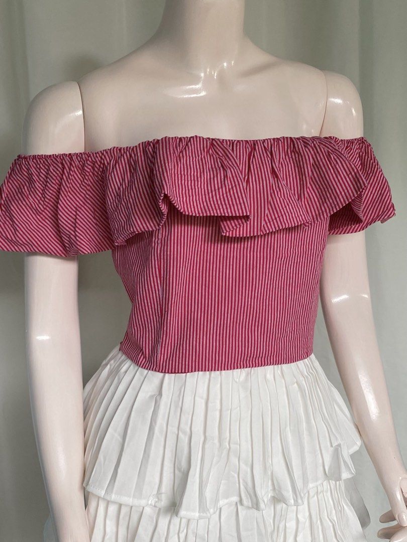 Pink Striped 2-way Ruffle Crop Top Size Small (Category: Blouses) located in Batangas. Submitted by mynne_09 (Listing ID 1470947823, Image 3). Description: - Color/Pattern: Pink and red striped - Size: Small (fits true to size) - Style: Versatile square neck or off-shoulder - Details: Cute ruffle trim on chest and sleeves - Perfect for: Casual days out, easily paired with high-waisted skirts or denim shorts.