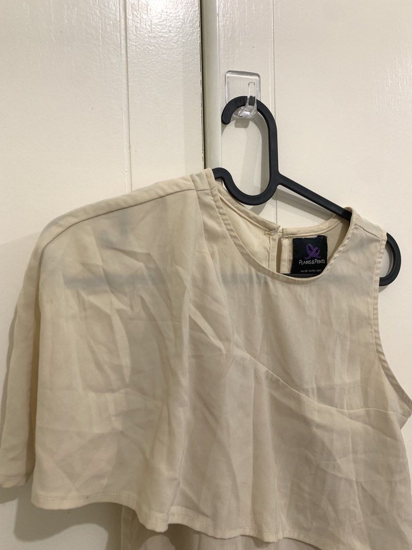 Plains & Prints Beige One Shoulder Layered Blouse (Category: Blouses) located in Pasig City. Submitted by lovedbyri (Listing ID 1471018354, Image 2). Description: - Brand: Plains & Prints - Color: Cream beige - Size: PH L / EUR S / USA 2 - Design: Asymmetrical overlay (one sleeve, one sleeveless side), round neckline, back keyhole with button closure - Material: Lightweight fabric - Style: Perfect for office or smart casual wear - Condition: Pre-