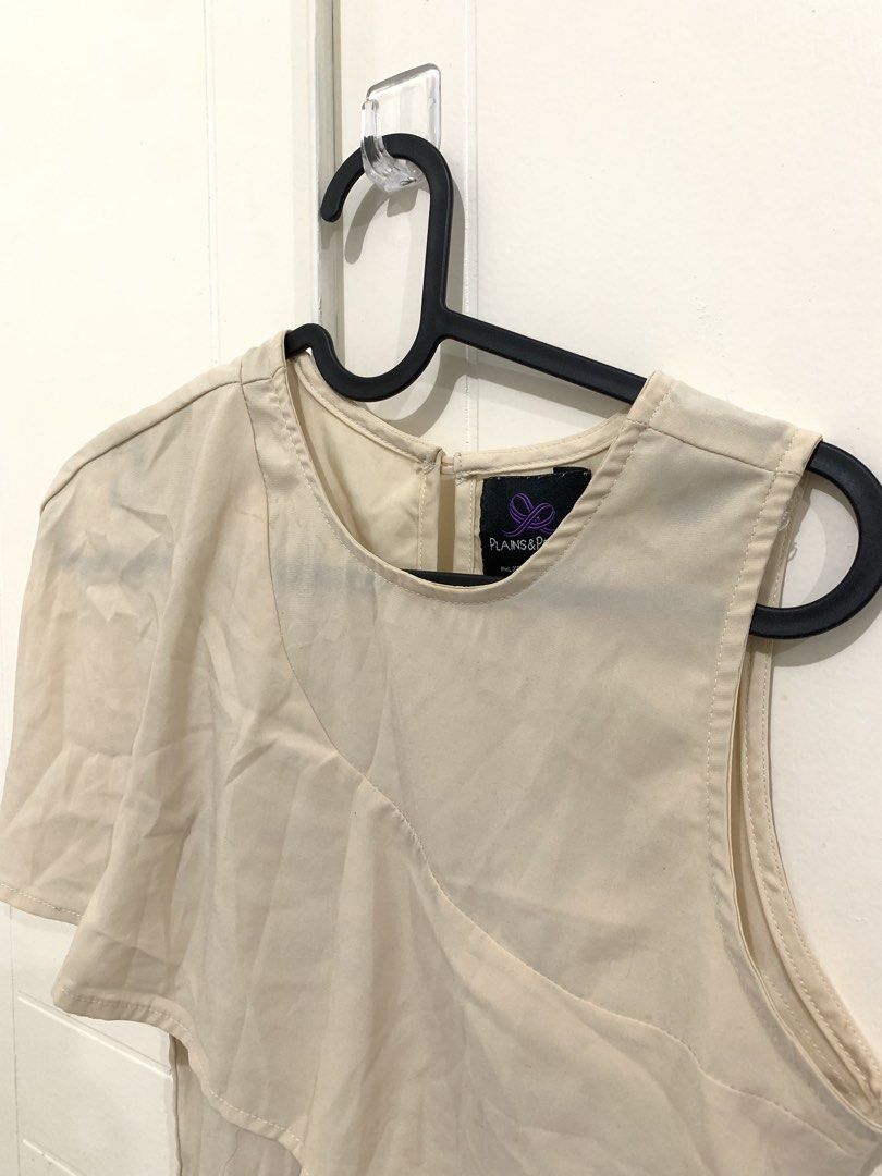 Plains & Prints Beige One Shoulder Layered Blouse (Category: Blouses) located in Pasig City. Submitted by lovedbyri (Listing ID 1471018354, Image 3). Description: - Brand: Plains & Prints - Color: Cream beige - Size: PH L / EUR S / USA 2 - Design: Asymmetrical overlay (one sleeve, one sleeveless side), round neckline, back keyhole with button closure - Material: Lightweight fabric - Style: Perfect for office or smart casual wear - Condition: Pre-
