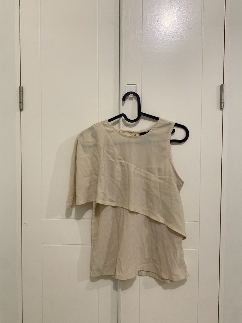 Plains & Prints Beige One Shoulder Layered Blouse (Category: Blouses) located in Pasig City. Submitted by lovedbyri (Listing ID 1471018354, Image 1). Description: - Brand: Plains & Prints - Color: Cream beige - Size: PH L / EUR S / USA 2 - Design: Asymmetrical overlay (one sleeve, one sleeveless side), round neckline, back keyhole with button closure - Material: Lightweight fabric - Style: Perfect for office or smart casual wear - Condition: Pre-