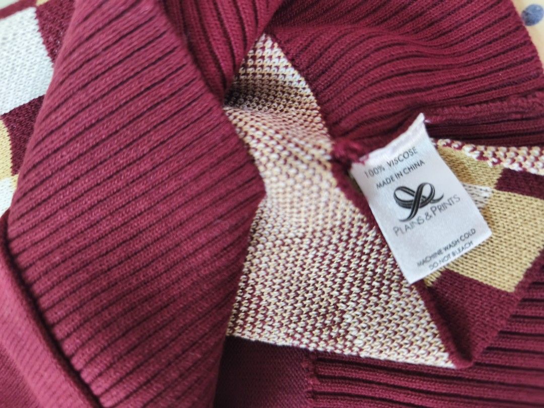 plains and prints sweater (Category: Sleeveless) located in Quezon City. Submitted by sweetiejoy (Listing ID 1470985210, Image 2). Description: Maroon knit sweater vest with a high mock neck collar. Front features a split design — left side is plaid, right side is checkered in cream, brown, and maroon tones. Ribbed hem and arm openings. Soft knit material. Great layering piece for cooler weather. fits xs-small.