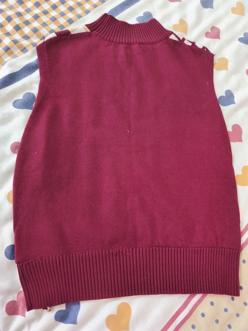 plains and prints sweater (Category: Sleeveless) located in Quezon City. Submitted by sweetiejoy (Listing ID 1470985210, Image 3). Description: Maroon knit sweater vest with a high mock neck collar. Front features a split design — left side is plaid, right side is checkered in cream, brown, and maroon tones. Ribbed hem and arm openings. Soft knit material. Great layering piece for cooler weather. fits xs-small.