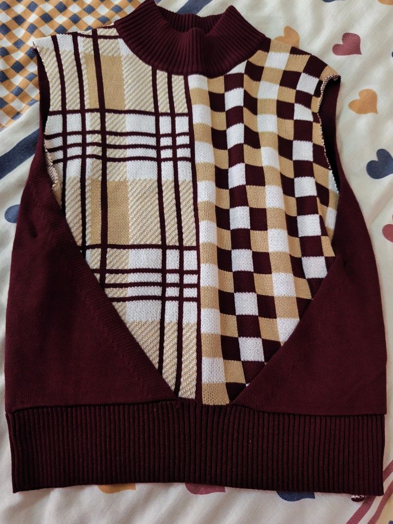 plains and prints sweater (Category: Sleeveless) located in Quezon City. Submitted by sweetiejoy (Listing ID 1470985210, Image 1). Description: Maroon knit sweater vest with a high mock neck collar. Front features a split design — left side is plaid, right side is checkered in cream, brown, and maroon tones. Ribbed hem and arm openings. Soft knit material. Great layering piece for cooler weather. fits xs-small.