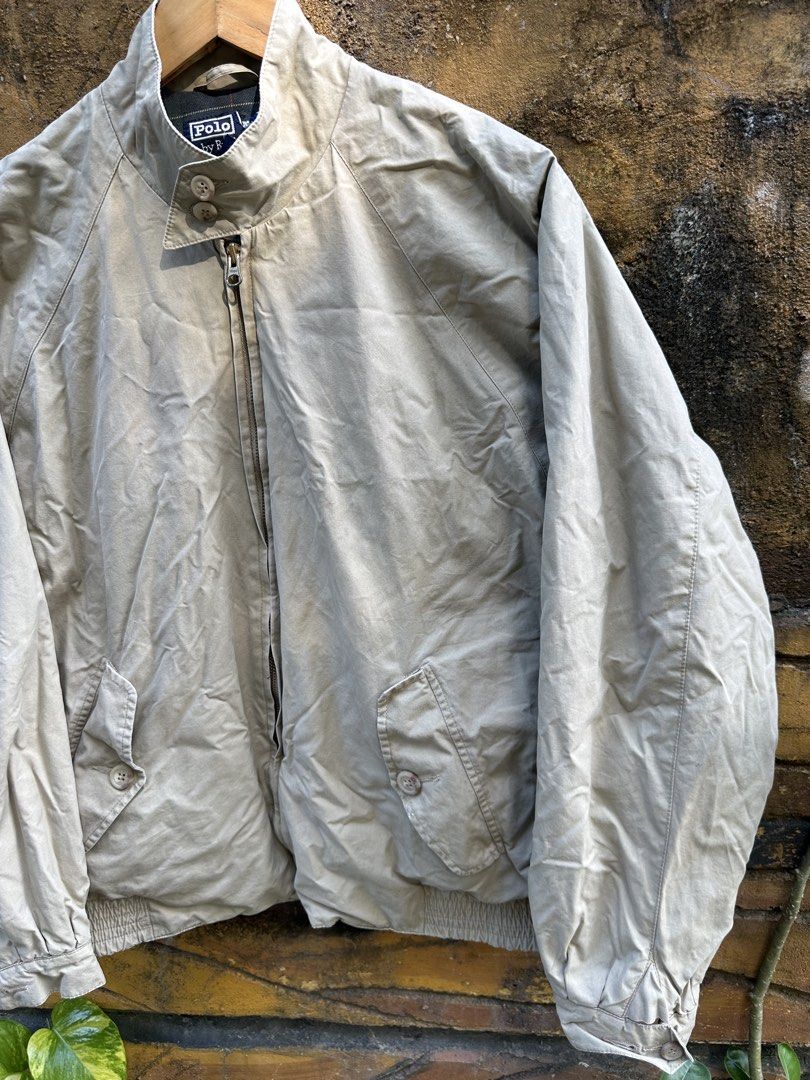 Polo Ralph Lauren Beige Harrington Jacket Plaid Lined (Category: Coats, Jackets and Outerwear) located in Urdaneta. Submitted by redeemedcollective (Listing ID 1471066567, Image 3). Description: Polo by Ralph Lauren Harrington-style jacket in a classic beige/khaki colorway, featuring a navy and green plaid interior lining. • Brand: Polo by Ralph Lauren • Color: Beige / Khaki • Size: Tag not clearly readable • Full front YKK zipper closure • Stand