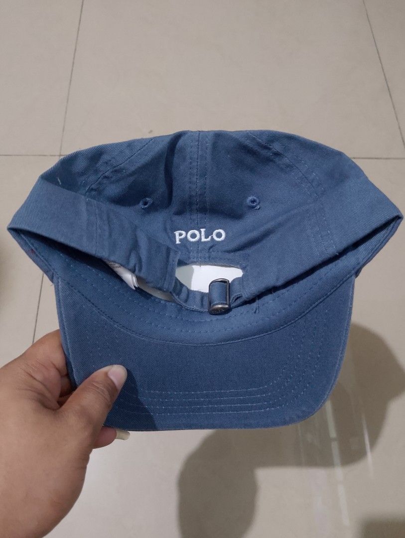 Polo Ralph Lauren Blue Baseball Cap (Category: Caps & Hats) located in Manila. Submitted by thriftyboyzzz (Listing ID 1470998968, Image 2). Description: - Brand: Polo Ralph Lauren - Color: Blue with white embroidery - Material: 100% Cotton (Made in Bangladesh) - Size: One size fits most (Size 5-7) - Details: White polo player logo on front, POLO text on back strap - Hardware: Adjustable metal buckle stamped with POLO - Condition: Clean interior t