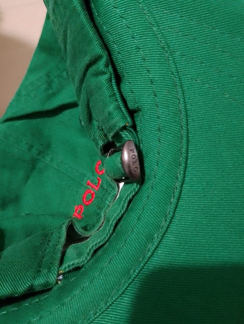 Polo Ralph Lauren Green Baseball Cap (Category: Caps & Hats) located in Manila. Submitted by thriftyboyzzz (Listing ID 1470998503, Image 3). Description: - Brand: Polo Ralph Lauren - Color: Green with red embroidered pony logo - Details: 'POLO' embroidered above the back strap, branded metal strap adjuster - Material: 100% cotton - Size: One size (fits 49cm-56cm) - Condition: Brand new with original tags attached - Origin: Made in Bangladesh.