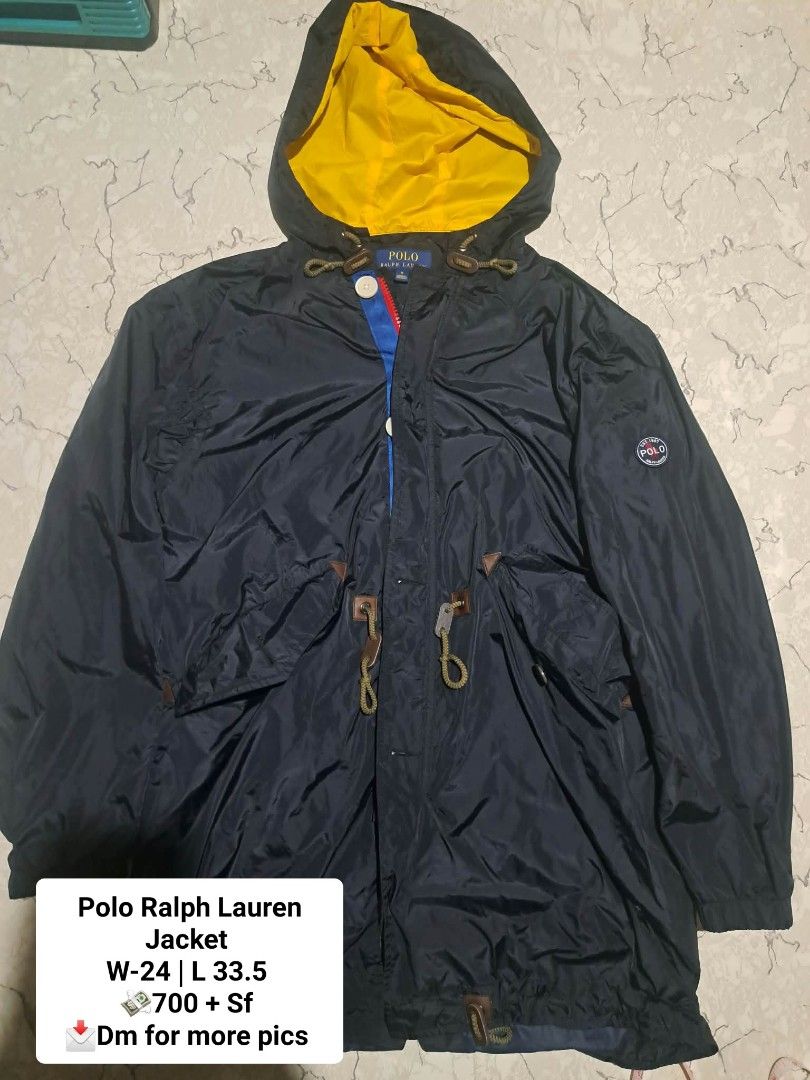 Polo Ralph Lauren Jacket Navy Yellow Size M (Category: Coats, Jackets and Outerwear) located in Manila. Submitted by alexson10 (Listing ID 1471068377, Image 1). Description: - Brand: Polo Ralph Lauren - Color: Navy blue with bright yellow hood and interior lining - Size: Medium (Made in Indonesia) - Closure: Front zipper with button flap overlay - Features: Adjustable drawstring waist and hem, side pockets with button flaps, and adjustable cuffs 