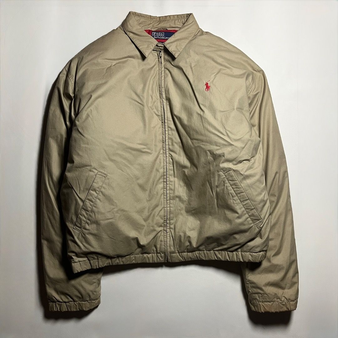 Polo Ralph Lauren Khaki Down Puffer Harrington Jacket (Category: Coats, Jackets and Outerwear) located in Caloocan City. Submitted by achilles_grails (Listing ID 1471052396, Image 1). Description: Polo by Ralph Lauren down jacket in khaki. Red quilted inner lining. Outer shell and inner lining are 100 percent cotton. Fill type is 80 percent down and 20 percent waterfowl feather. Dry clean only. Size M tag on the collar. Classic embroidered red lo