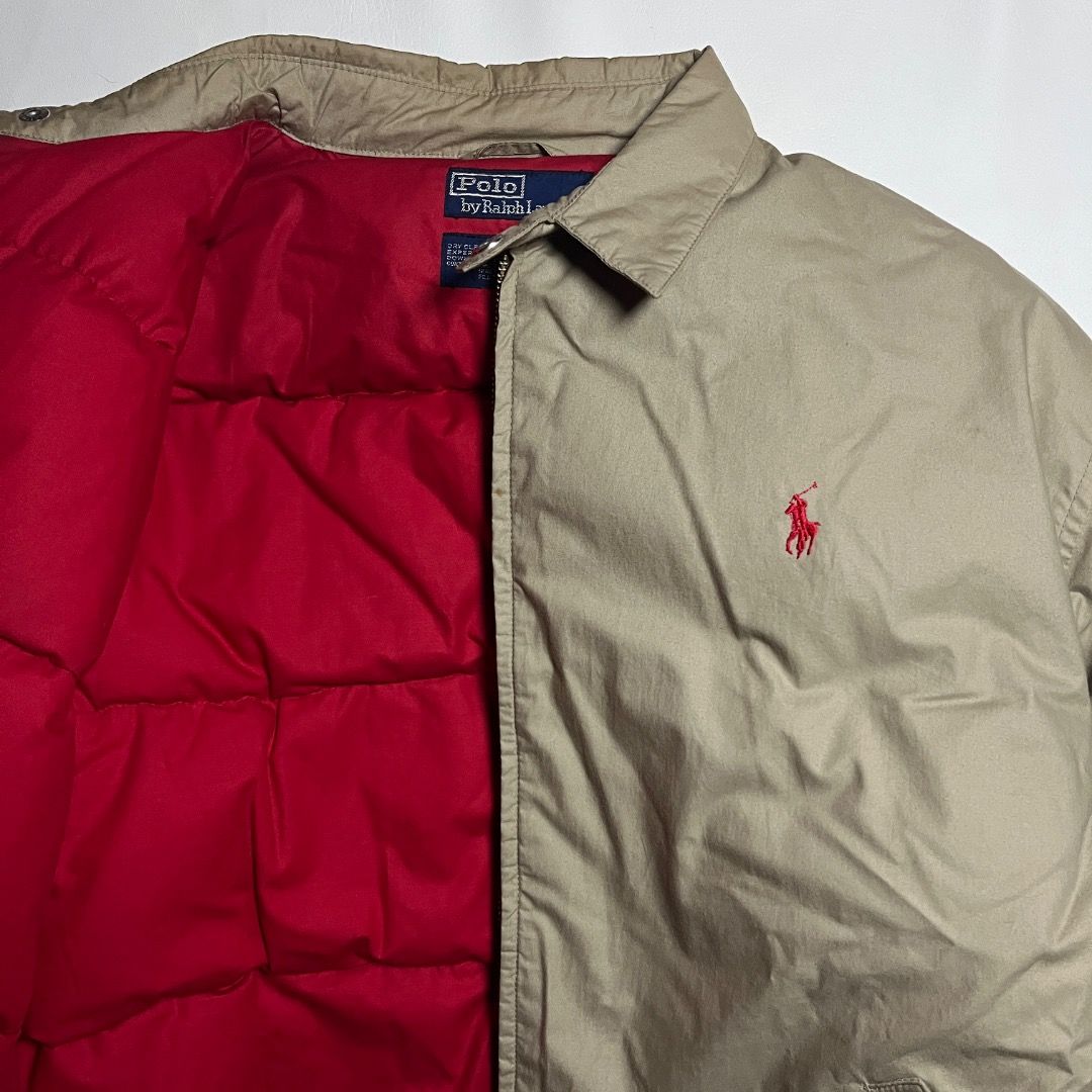 Polo Ralph Lauren Khaki Down Puffer Harrington Jacket (Category: Coats, Jackets and Outerwear) located in Caloocan City. Submitted by achilles_grails (Listing ID 1471052396, Image 2). Description: Polo by Ralph Lauren down jacket in khaki. Red quilted inner lining. Outer shell and inner lining are 100 percent cotton. Fill type is 80 percent down and 20 percent waterfowl feather. Dry clean only. Size M tag on the collar. Classic embroidered red lo
