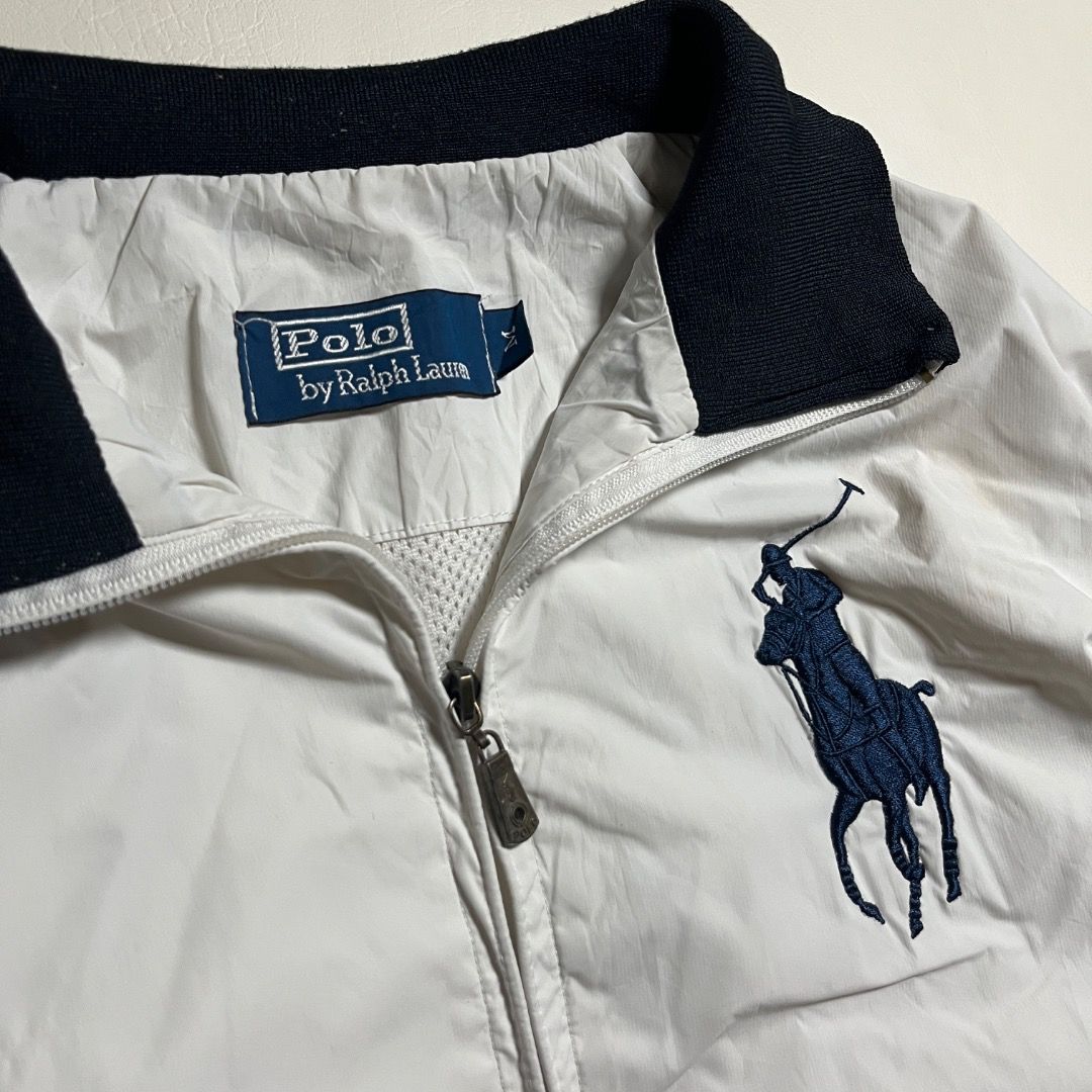 Polo Ralph Lauren White Track Jacket (Category: Coats, Jackets and Outerwear) located in Caloocan City. Submitted by achilles_grails (Listing ID 1471046801, Image 3). Description: - Brand: Polo by Ralph Lauren - Color: White with navy blue accents - Design: Iconic big pony embroidery on chest, number '3' patch on right sleeve - Details: Striped ribbed collar, cuffs, and hem; dual zipped front pockets - Lining: Breathable white mesh inner lining -