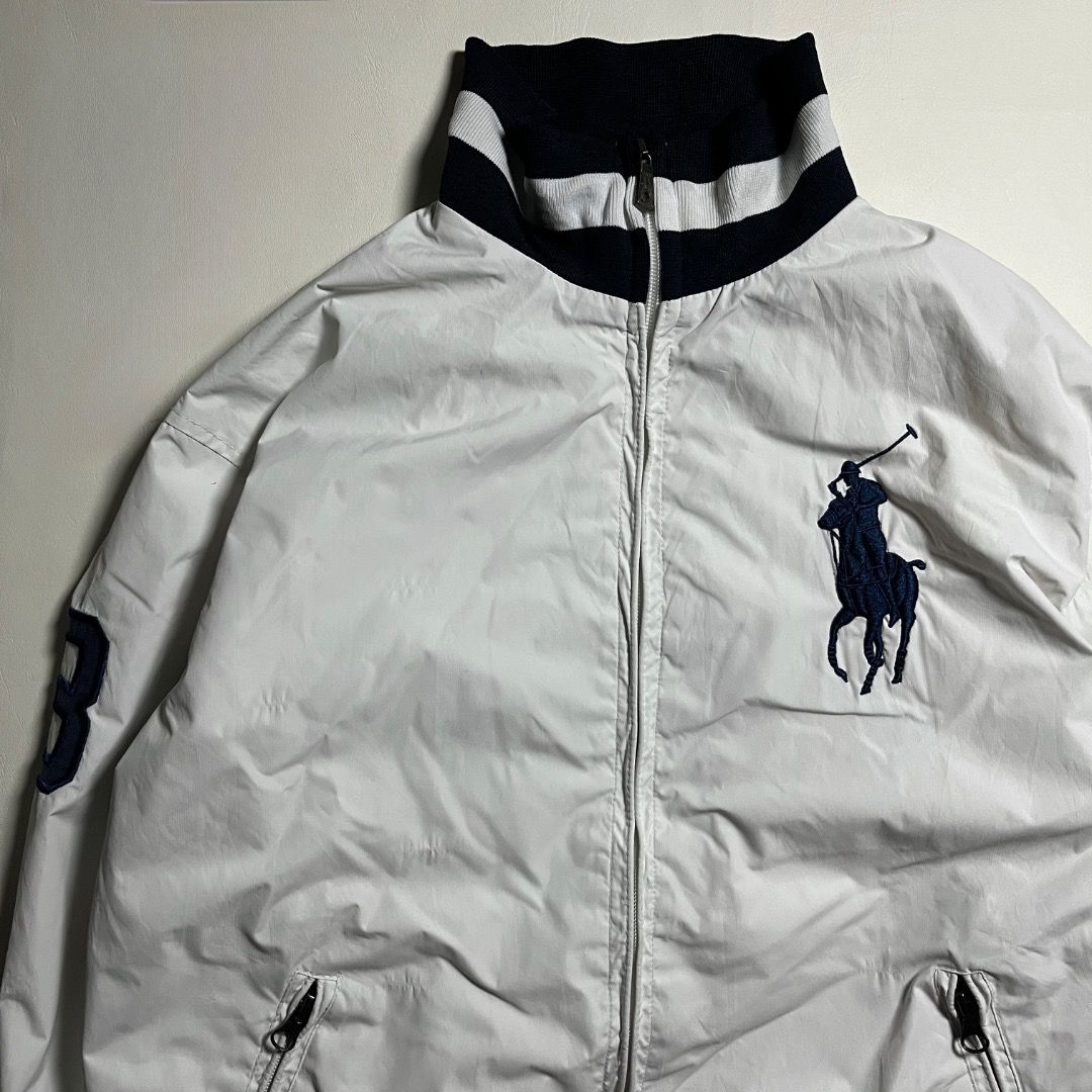 Polo Ralph Lauren White Track Jacket (Category: Coats, Jackets and Outerwear) located in Caloocan City. Submitted by achilles_grails (Listing ID 1471046801, Image 2). Description: - Brand: Polo by Ralph Lauren - Color: White with navy blue accents - Design: Iconic big pony embroidery on chest, number '3' patch on right sleeve - Details: Striped ribbed collar, cuffs, and hem; dual zipped front pockets - Lining: Breathable white mesh inner lining -