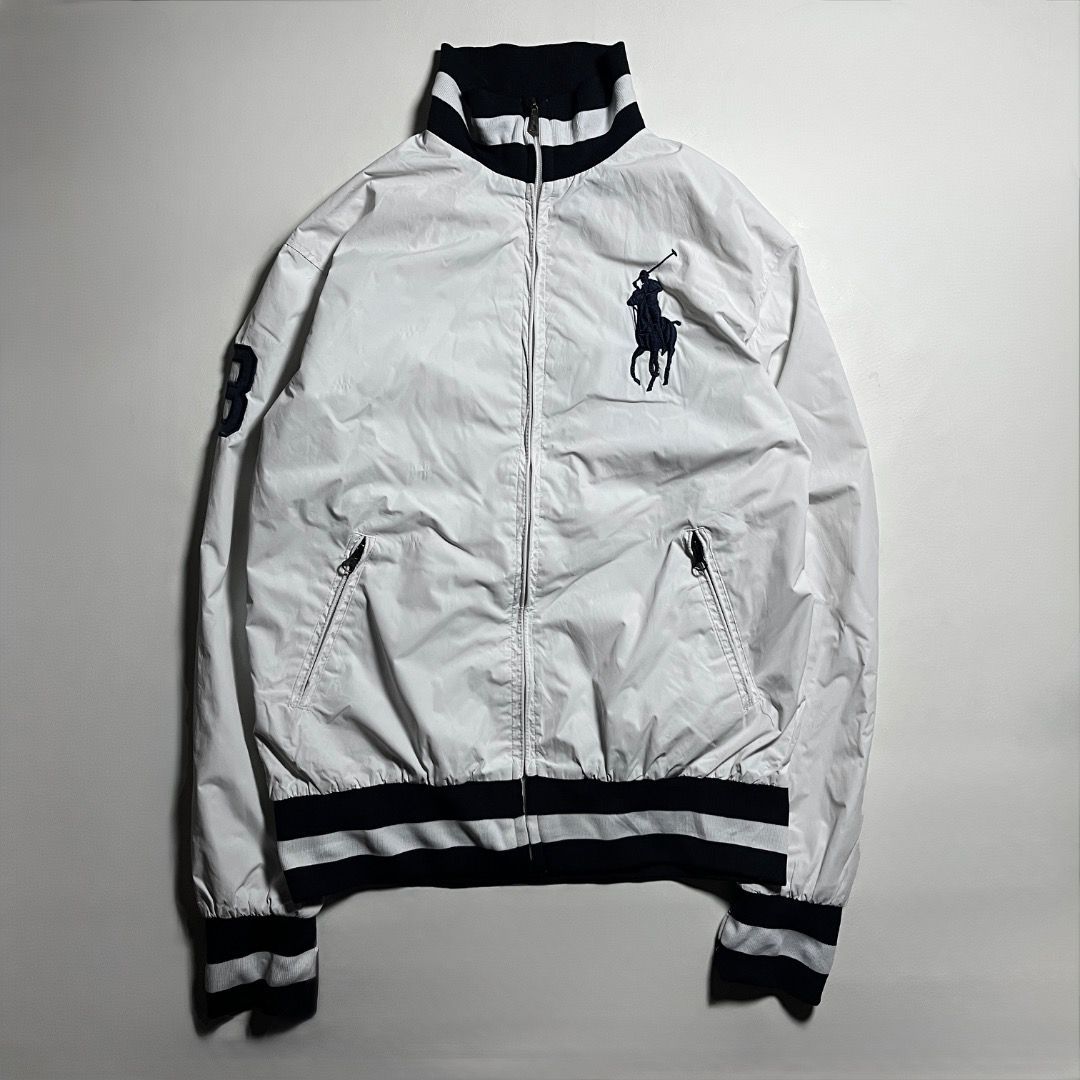 Polo Ralph Lauren White Track Jacket (Category: Coats, Jackets and Outerwear) located in Caloocan City. Submitted by achilles_grails (Listing ID 1471046801, Image 1). Description: - Brand: Polo by Ralph Lauren - Color: White with navy blue accents - Design: Iconic big pony embroidery on chest, number '3' patch on right sleeve - Details: Striped ribbed collar, cuffs, and hem; dual zipped front pockets - Lining: Breathable white mesh inner lining -