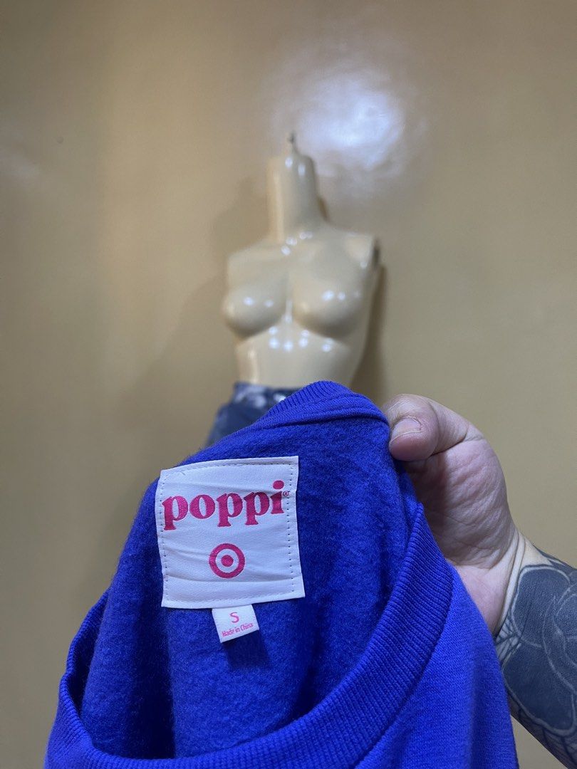 Poppi Blue Sweatshirt Size Small (Category: Coats, Jackets and Outerwear) located in Naga. Submitted by 2ndusedclothingstore (Listing ID 1471072165, Image 3). Description: - Brand: Poppi - Color: Blue - Size: Small (fits like S-to-M with a relaxed oversized fit) - Design: Small embroidered text on the front chest - Back Detail: Large graphic print with abstract lettering and star accents - Fit/Style: Crew neckline, long sleeves, ribbed cuffs and 