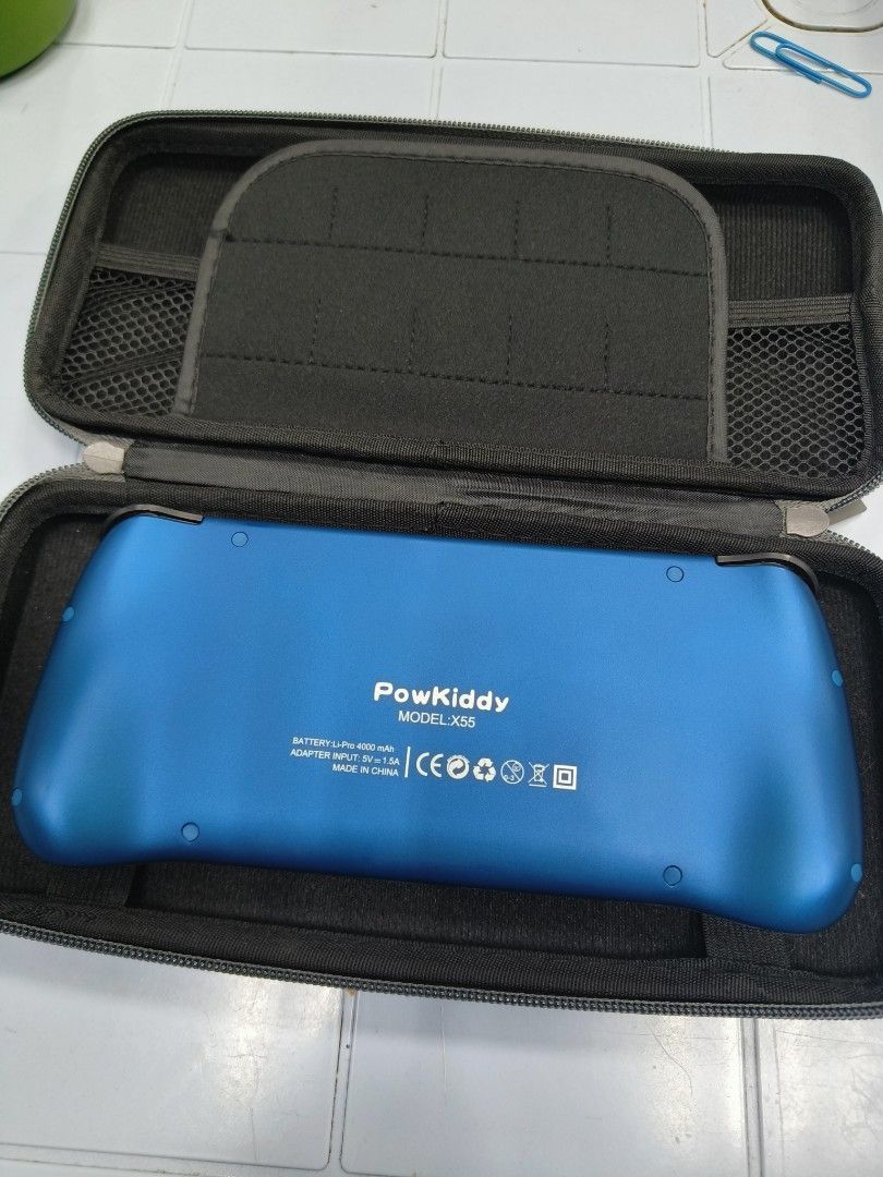 Powkiddy X55 Handheld Retro Game Console Blue (Category: Nintendo) located in Manila. Submitted by bigtym.picker (Listing ID 1470934206, Image 2). Description: almost new hi di halos nagamit unit only w/ case no charger slight nego - Model: Powkiddy X55 Handheld Console (Blue) - OS: Runs ROCKNIX operating system - Accessories: Includes fitted hard storage case with zipper and mesh pockets - Condition: Clean outer shell with fully functional scree