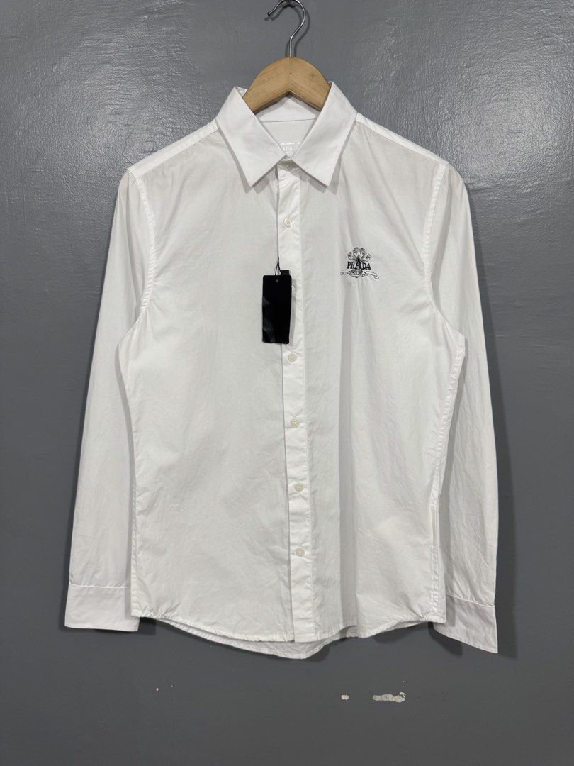 Prada - Button Up Long Sleeve Polo (Category: Tshirts & Polo Shirts ) located in Manila. Submitted by sophisticatedgoons (Listing ID 1471043145, Image 1). Description: Prada White Polo Long Sleeve Size: Small Dimes: 19 x 27-29 Brandnew with tag No issue Needs little wash.