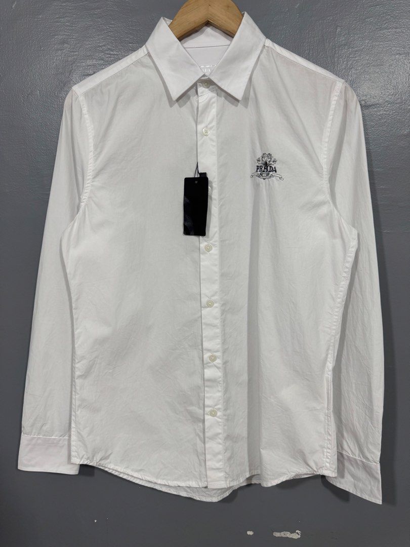 Prada - Button Up Long Sleeve Polo (Category: Tshirts & Polo Shirts ) located in Manila. Submitted by sophisticatedgoons (Listing ID 1471043145, Image 2). Description: Prada White Polo Long Sleeve Size: Small Dimes: 19 x 27-29 Brandnew with tag No issue Needs little wash.